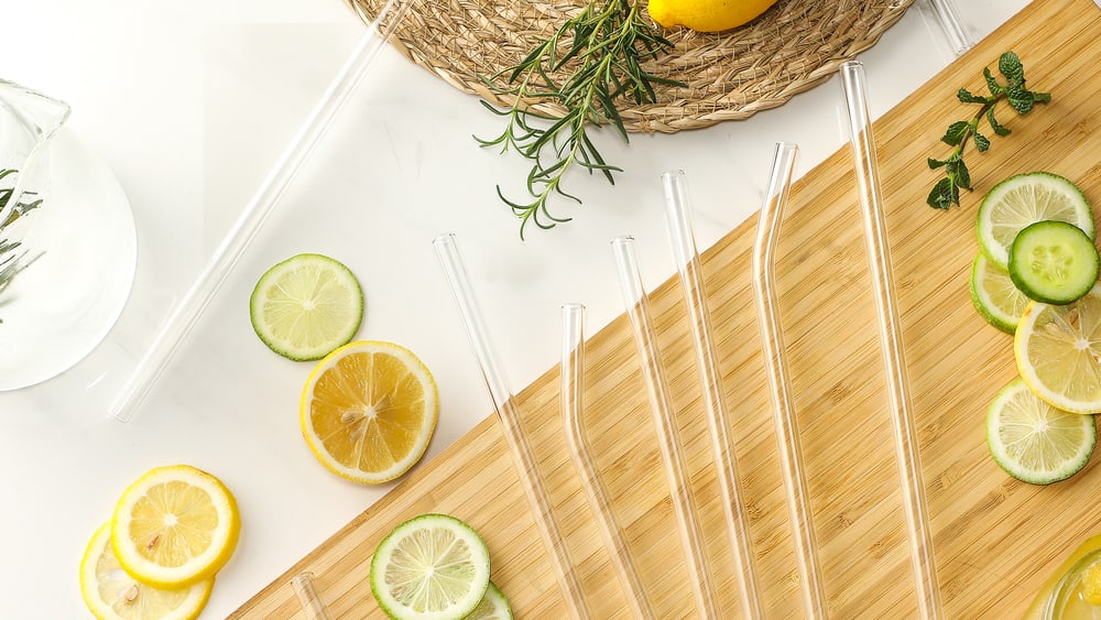 Glass straws and citrus slices on a marble counter